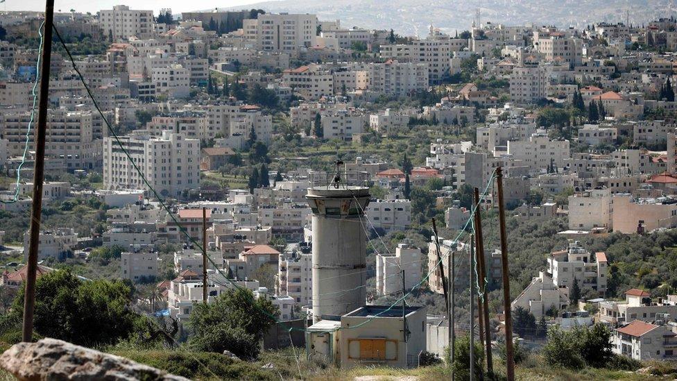 A picture taken from a settlement in east Jerusalem shows an Israeli army watchtower overlooking the Palestinian town of Beit Jala