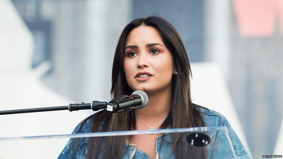 Demi Lovato talking to a crowd