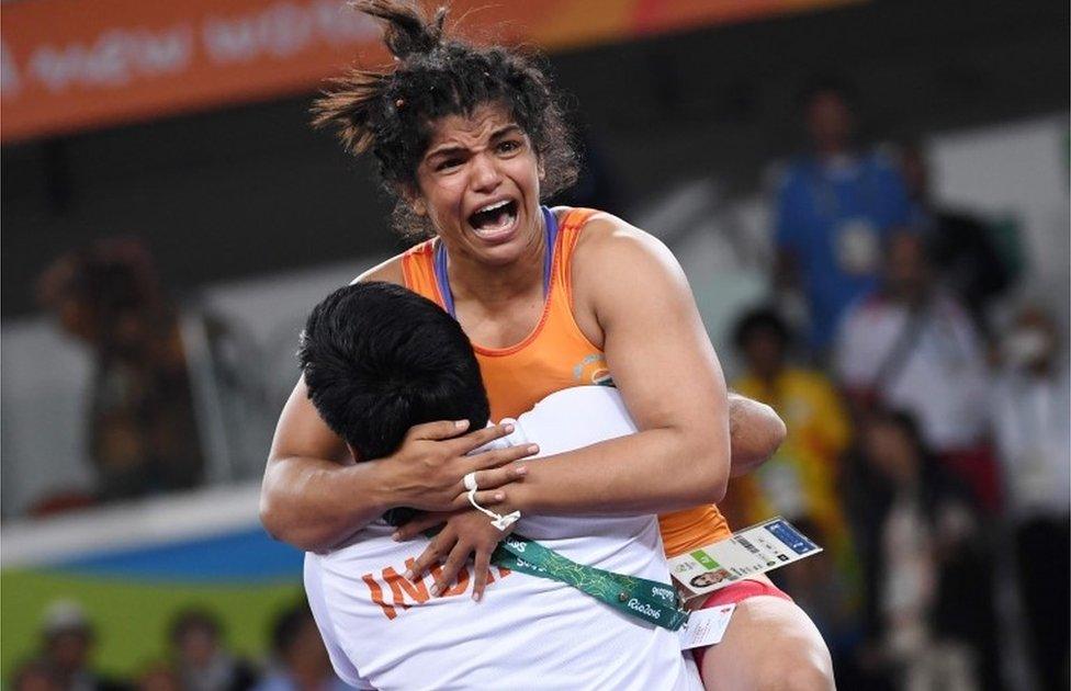 India"s Sakshi Malik celebrates after winning against Kirghyzstan"s Aisuluu Tynybekova in their women"s 58kg freestyle bronze medal match on August 17, 2016, during the wrestling event of the Rio 2016 Olympic Games at the Carioca Arena 2 in Rio de Janeiro.