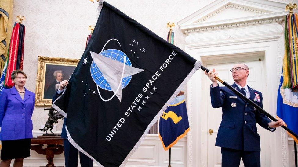 Man holding US Space Force flag.