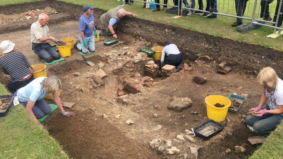 Archaeologists excavating the Roman bath house in Chichester