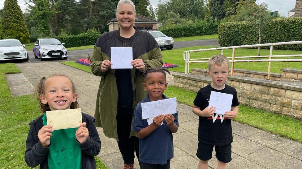 Chloe Elizabeth Hill with children using the postbox