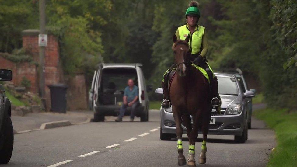 Alison on a horse on the road