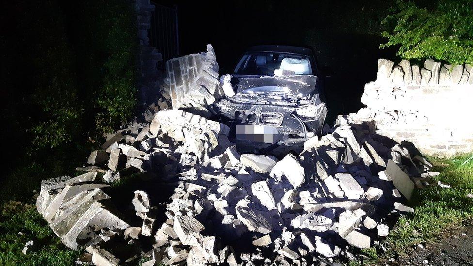 The car and the demolished wall