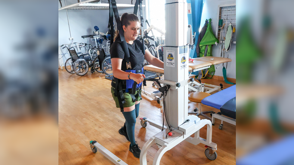 Megan Field using the LiteGait, which has a harness around her and a frame