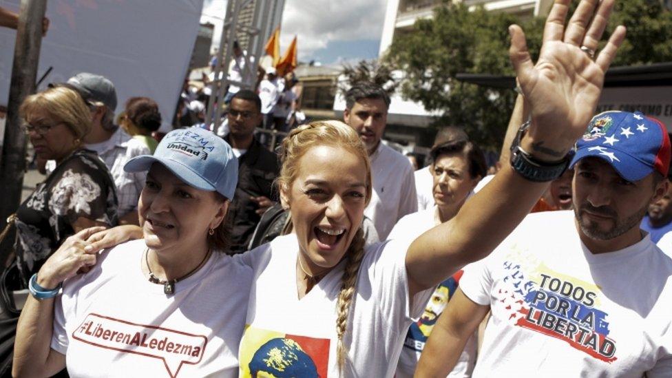 Lilian Tintori (C), wife of jailed opposition leader Leopoldo Lopez, greets supporters next to Mitzy de Ledezma (front L), wife of arrested Caracas metropolitan mayor Antonio Ledezma, as she arrives to a campaign rally of deputies candidates for the National Assembly for the Venezuelan coalition of opposition parties Democratic Unity Roundtable (MUD), in Caracas, November 29, 2015