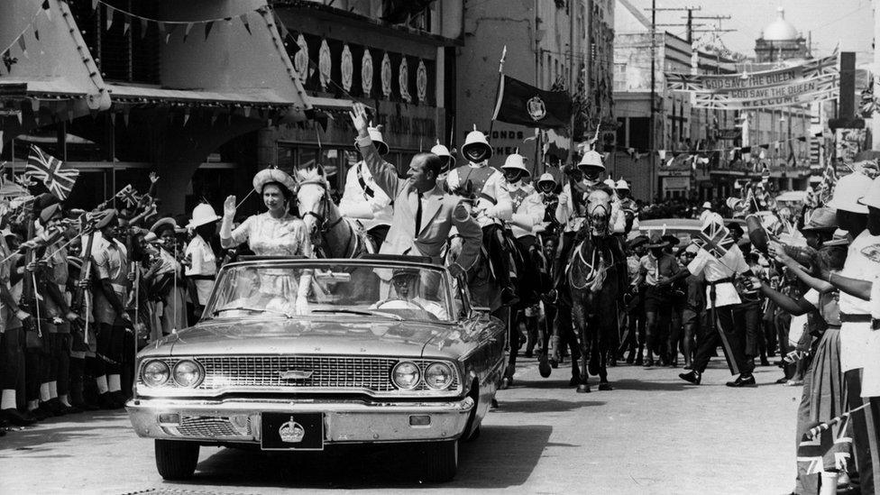 18th February 1966: The Queen and Prince Philip driving through Barbados waving to the crowds.