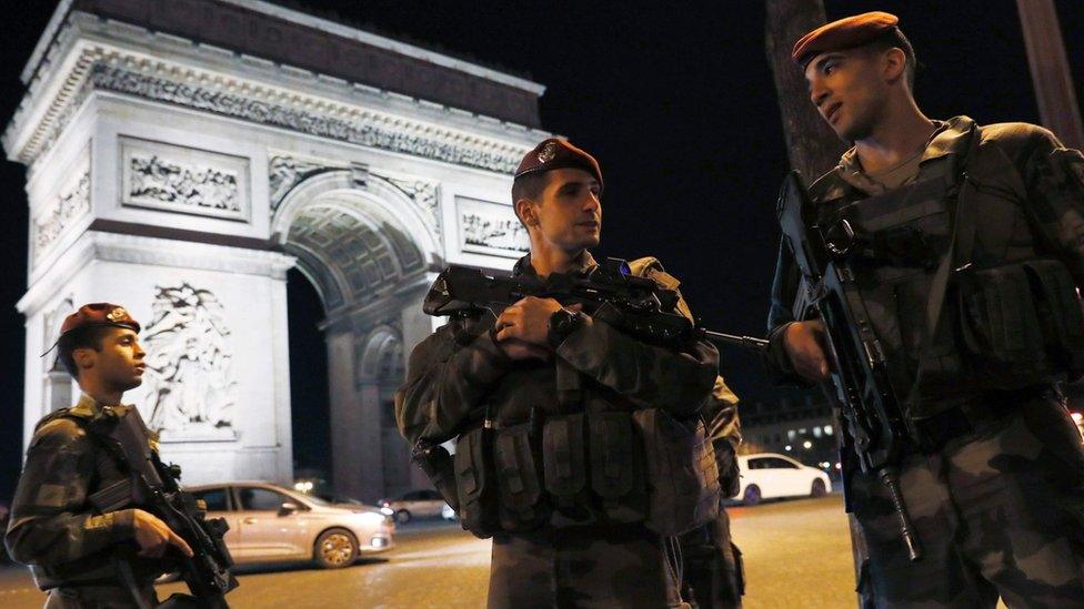 French soldiers stand guard at the Arc de Triomphe near the Champs Elysees in Paris after a shooting on April 20, 2017.