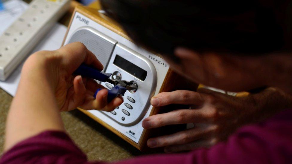 A man repairs a radio