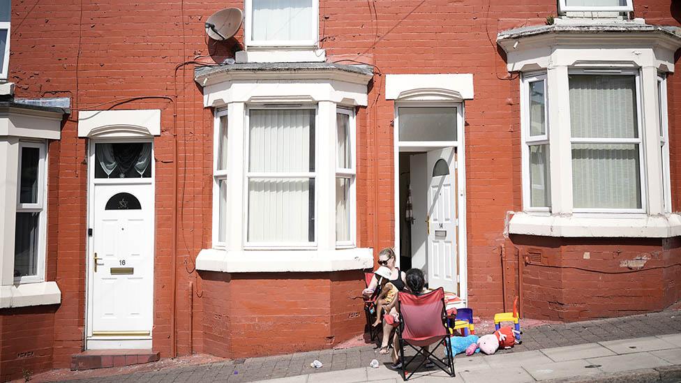 Women sunbathing in street in Liverpool