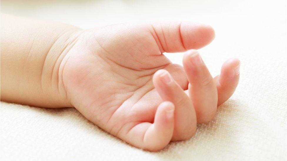 Baby hand - stock photo