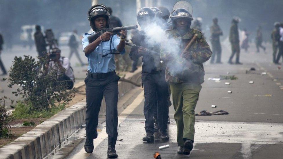 Riot police fire tear gas toward demonstrators as they flee, during a protest in downtown Nairobi, Kenya Monday, May 16, 2016