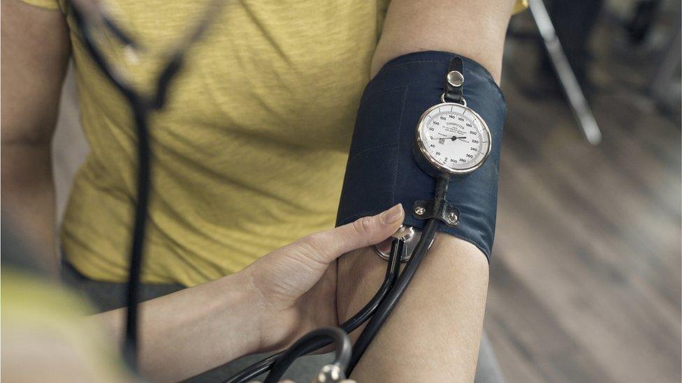 woman having her blood pressure checked