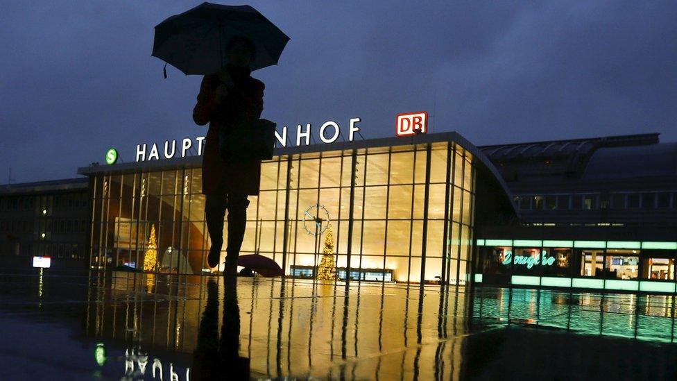 A woman walks in front of the main railway station in Cologne