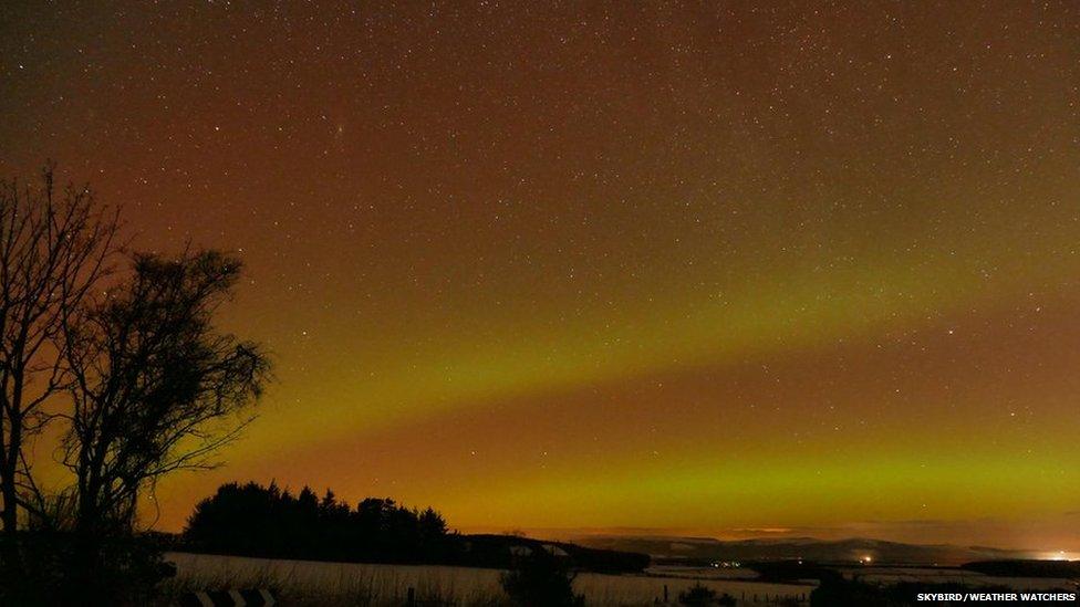 Orangey sky with the Northern Lights