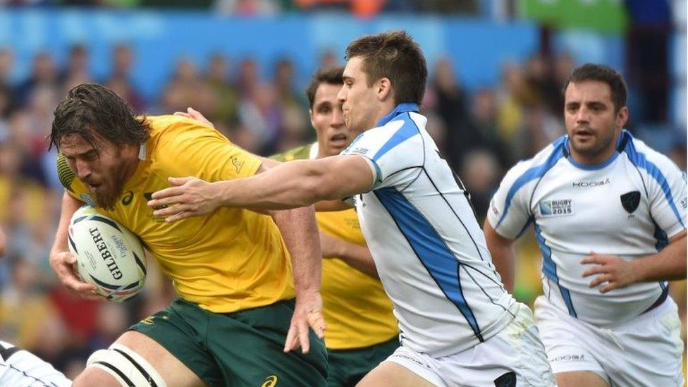 Australia's lock Kane Douglas (L) makes a break during the Pool A match of the 2015 Rugby World Cup between Australia and Uruguay at Villa Park in Birmingham, north England on September 27, 2015.