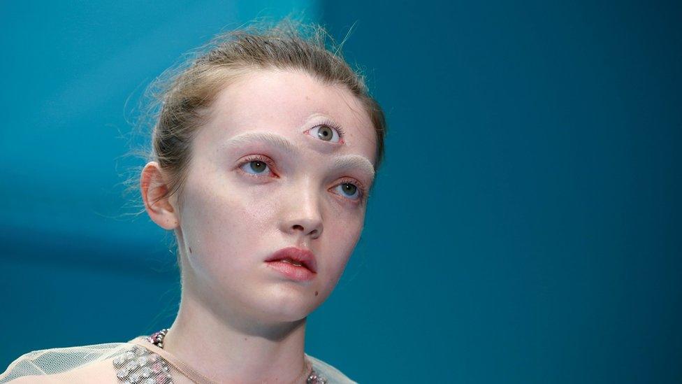 Female model with a prosthetic third eye attached to her forehead