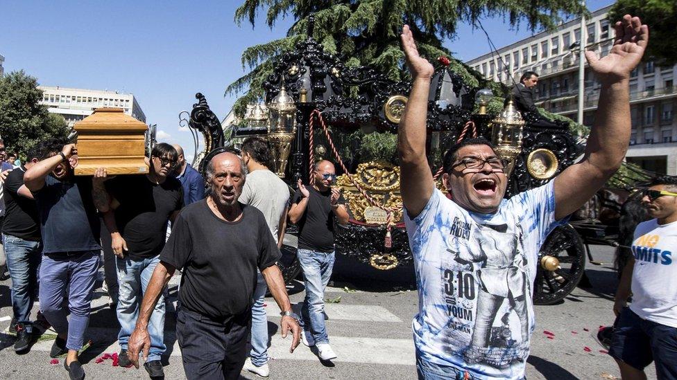 People attend the funeral procession of alleged mafia member Vittorio Casamonica, outside Don Bosco church in Rome, Italy, 20 August 2015