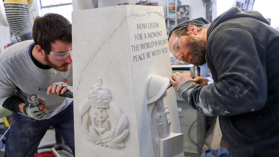 Prisoners carving a war memorial