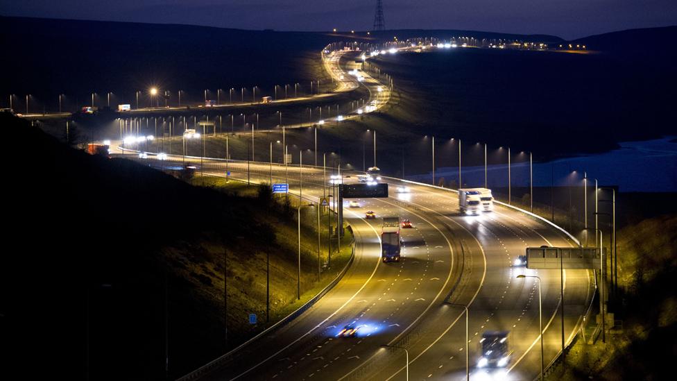 Traffic passes along the M62 motorway at night near the town of Shaw in Greater Manchester, north west England on April 7, 2015