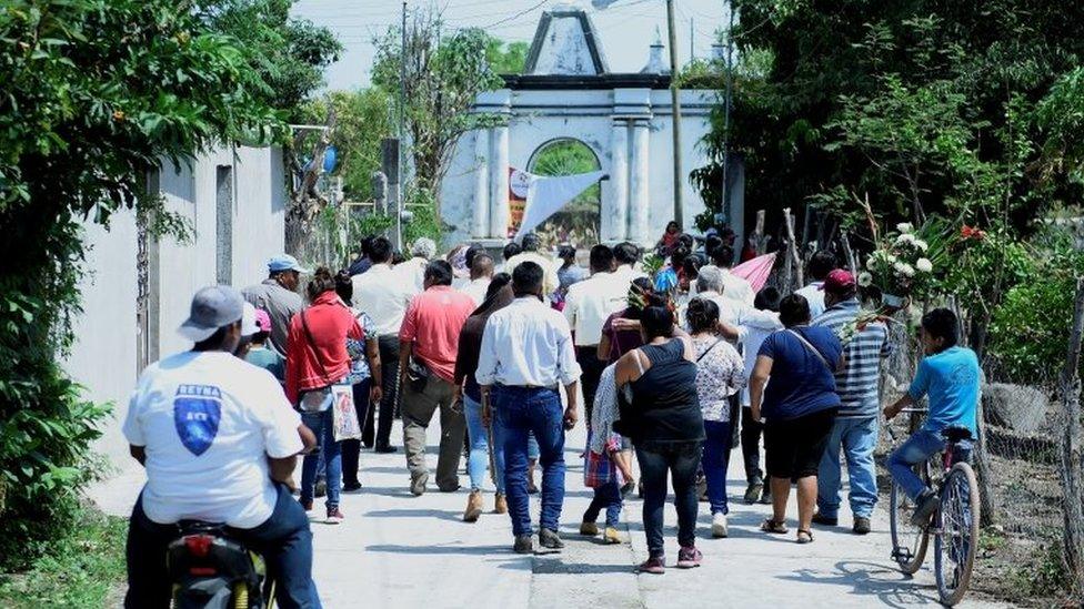 Inhabitants of the Telixtac indigenous community move the remains of a person who died after ingesting allegedly adulterated alcohol, in the municipality of Axochiapan in the state of Morelos, Mexico, 12 May 2020