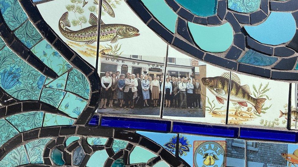 Staff of the Duke of York pub in a mosaic in blues and greens