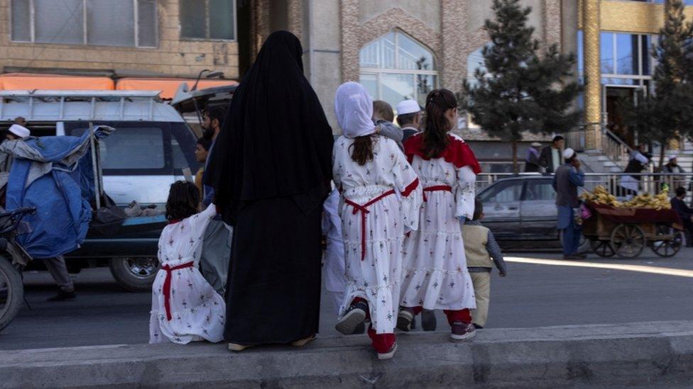 Family crossing the road in Kabul