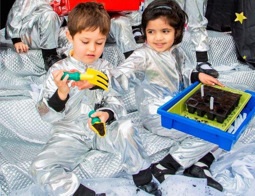 Children planting rocket seeds