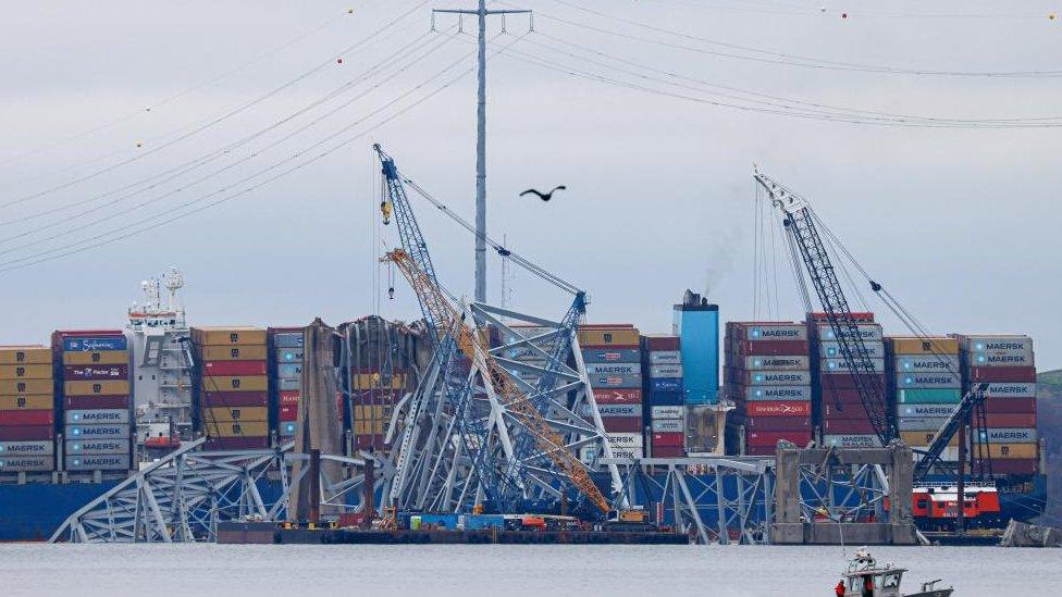 Wreckage from the Francis Scott Key Bridge surrounds the Dali cargo ship