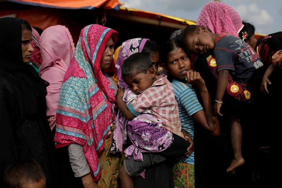 Rohingya refugees line up for a food supply distribution at the Kutupalong refugee camp near Cox's Bazar, Bangladesh 12 December 2017.