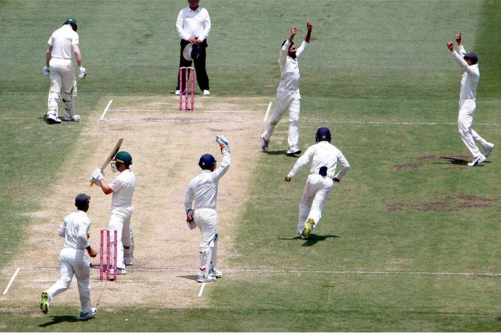 Australia"s Marcus Harris (bottom 2nd L) reacts after being dismissed as India"s captain Virat Kohli (R) celebrates with teammate Ravindra Jadeja during the third day"s play of the fourth and final cricket Test between India and Australia at the Sydney Cricket Ground on January 5, 2019.