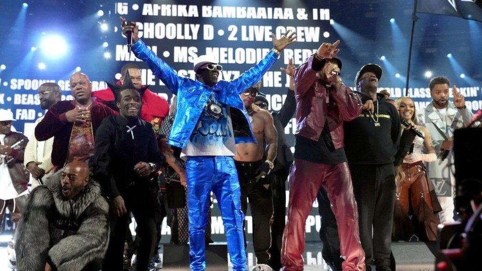 Performers such as LL Cool J, Flavor Flav, Busta Rhymes, Lil Uzi Vert, Nelly, Spliff Star, Queen Latifah, Ice-T, Chuck D, Joseph Simmons, Darryl McDaniels, Grandmaster Flash, and Black Thought perform on stage at the Grammys