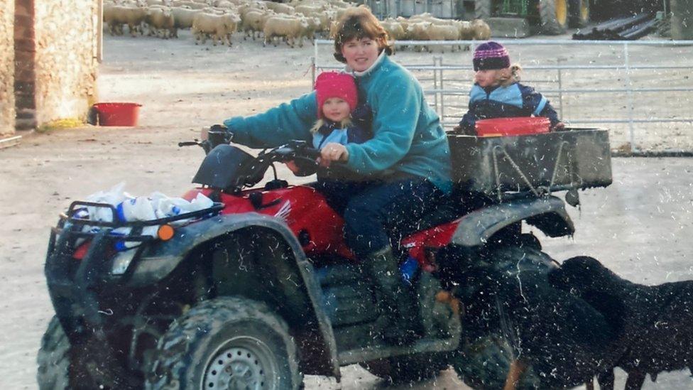 Mali on the farm as a child with her sister and mother.