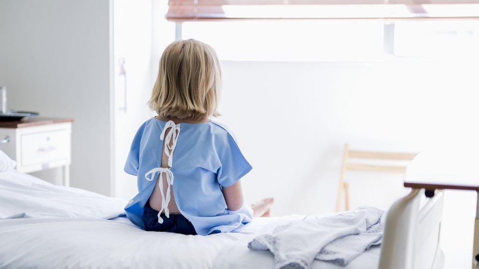 Young girl sitting on a hospital bed