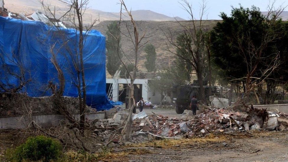 Wreckage in front of a Turkish military police station, which has been covered by a tarpaulin, after a suicide attack 02/08/2015