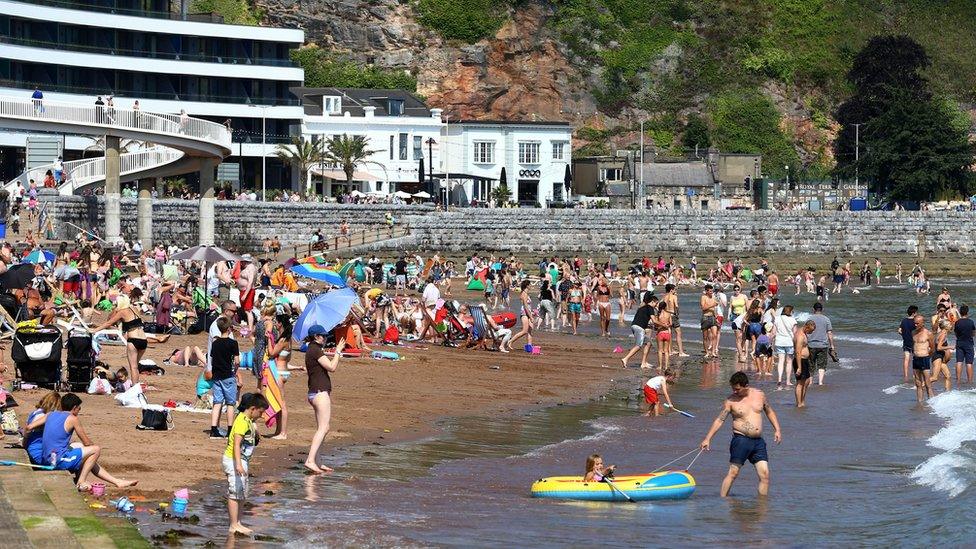 People on the beach in Torquay, in Devon