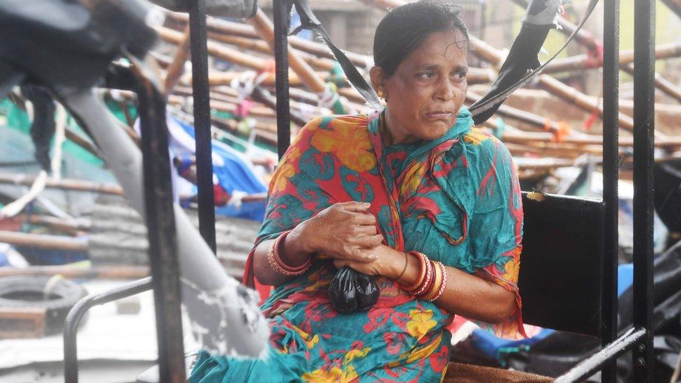 An Indian resident sits on an electric rickshaw next to a damaged structure after Cyclone Fani landfall in Puri in the eastern Indian state of Odisha on May 3, 2019