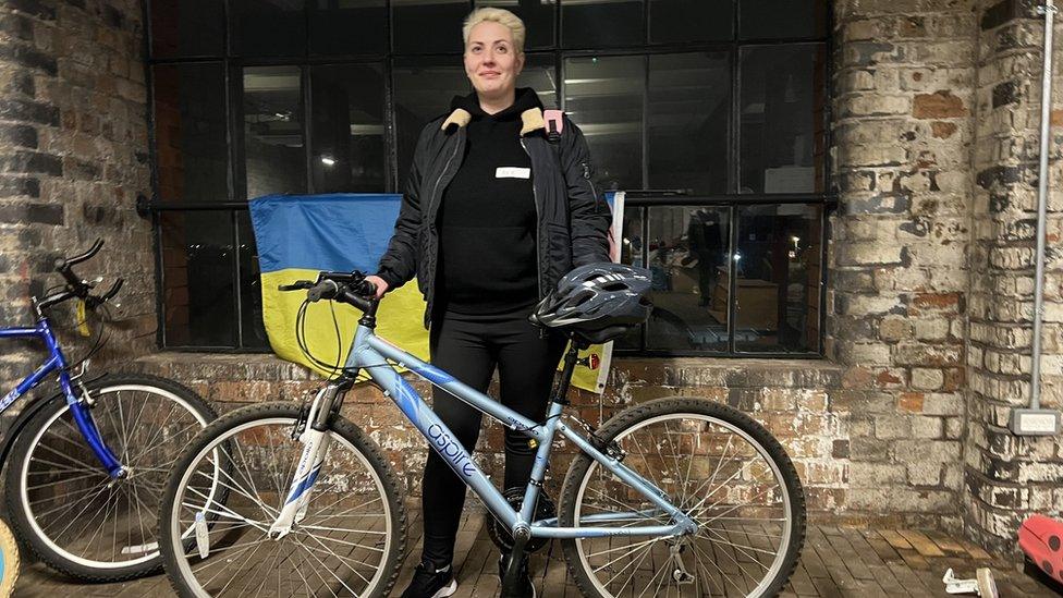 Woman standing with bike