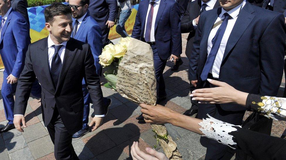 Ukraine"s President Volodymyr Zelensky is greeted by supporters as he leave after the inauguration ceremony at the parliament in Kiev on May 20, 2019.