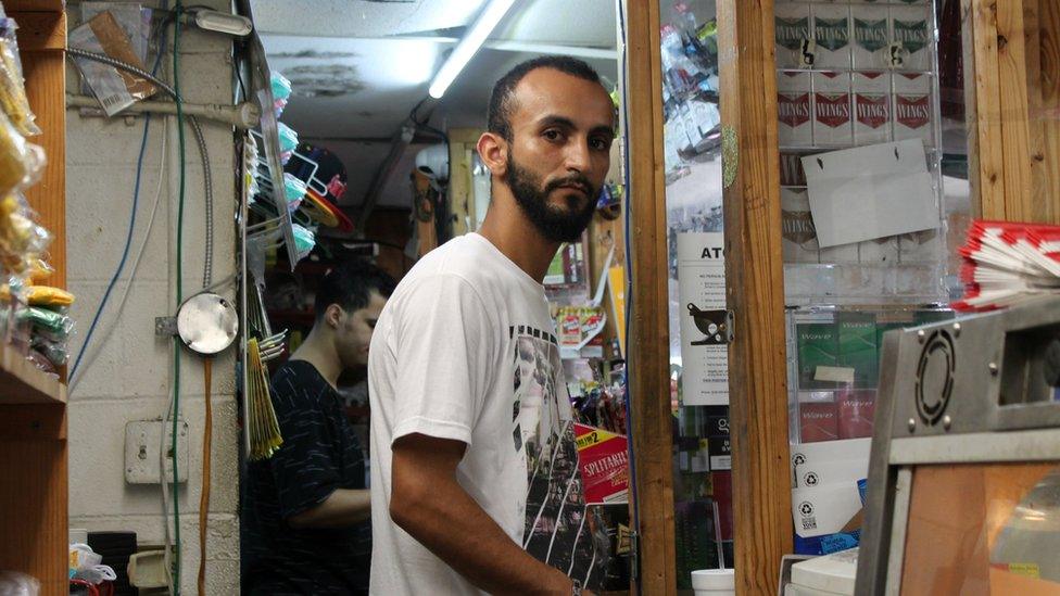 Abdullah Muflahi behind the counter at Triple S Food Mart in Baton Rouge, Louisiana