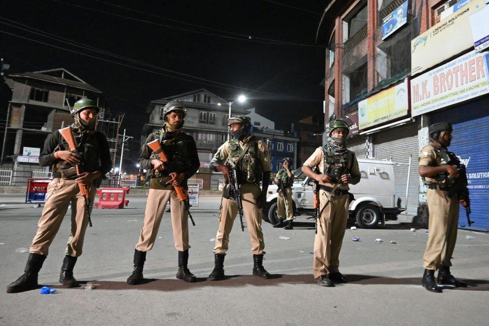 Indian paramilitary troopers stand guard at a roadblock at Maisuma locality in Srinagar on August 4, 2019.