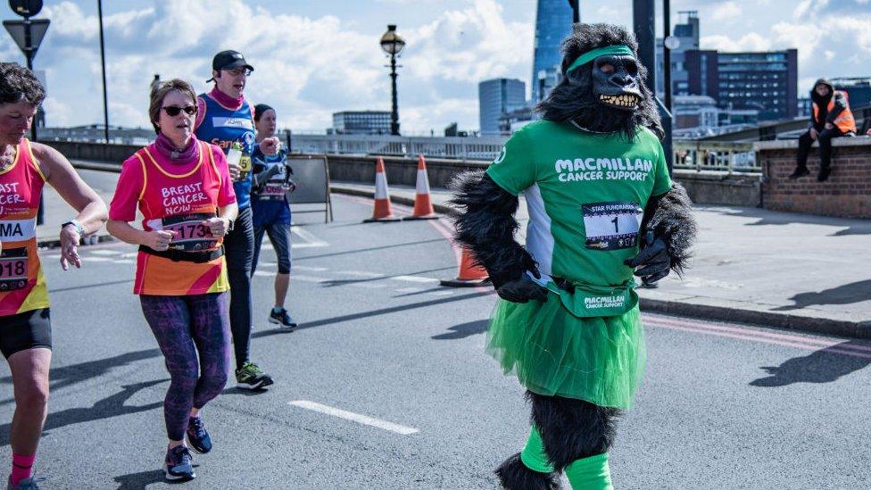 Person in gorilla suit running London marathon.