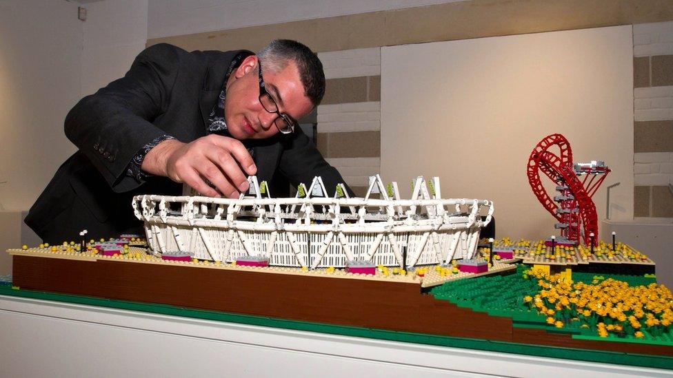 Warren Elsmore puts the finishing touches to his Lego version of the Olympic Park in London