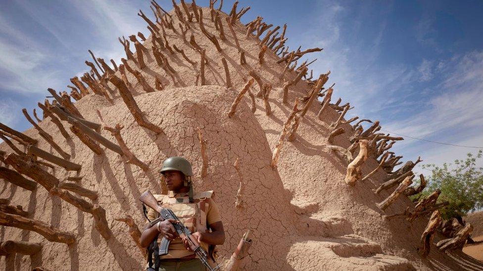 A soldier of the Malian army patrols the archaeological site of the Tomb of Askia in Gao on March 10, 2020.