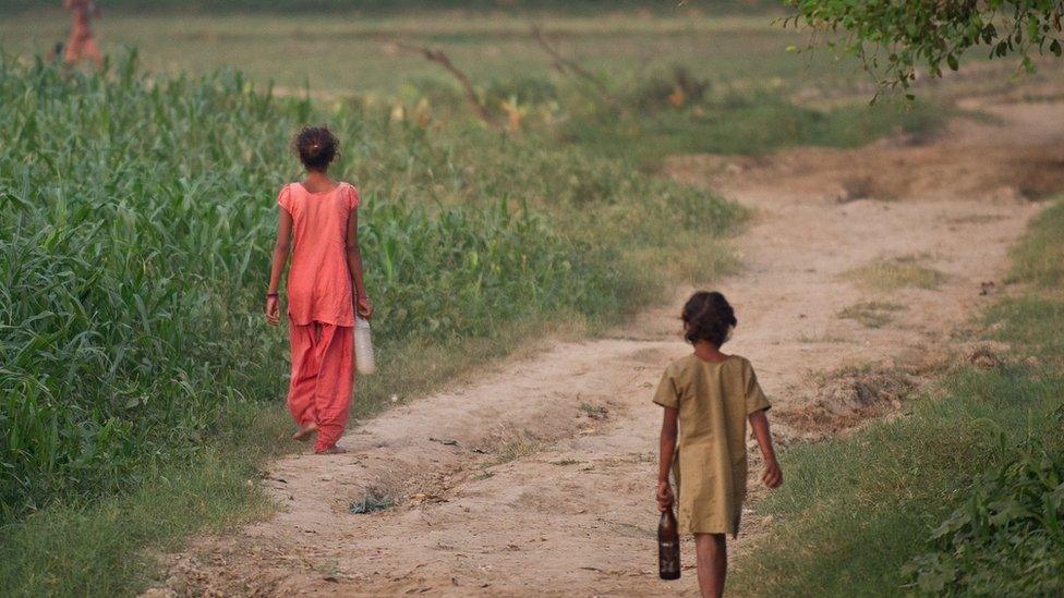 Children walk through the fields in Badaun district of Uttar Pradesh in India