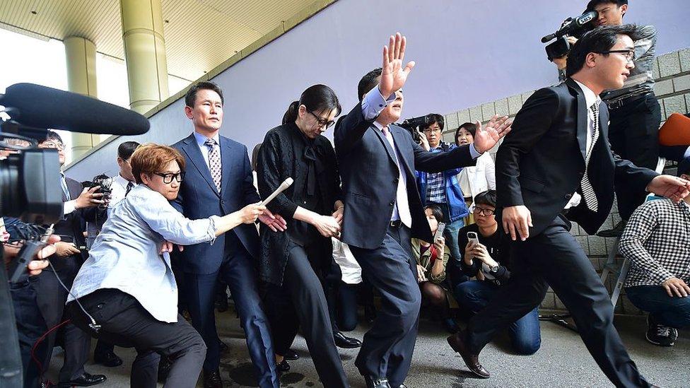 Former Korean Air (KAL) executive Cho Hyun-Ah (C) leaves after she received a suspended jail sentence and was freed by a Seoul appeals court in Seoul on May 22, 2015, after she had been jailed for a year in February for disrupting a flight in a rage over macadamia nuts.