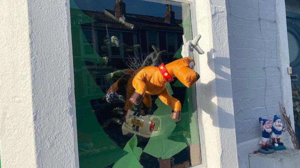 Reindeer toy coming through a window