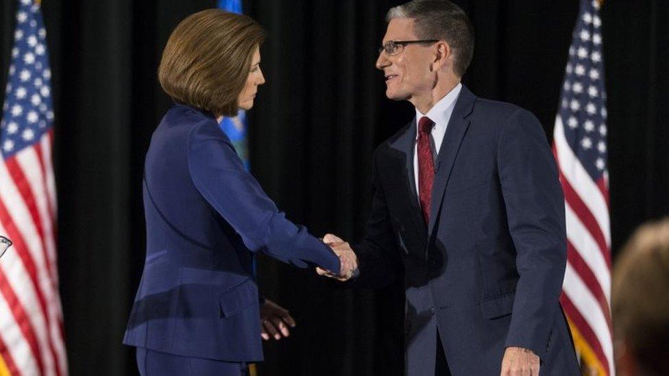 Democratic US Senate candidate Catherine Cortez Masto shakes hands with US Representative Joe Heck.