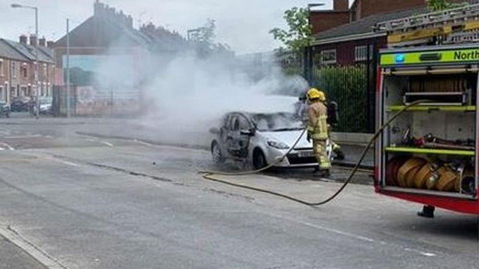 Northern Ireland Fire and Rescue Service putting out the car fire in west Belfast