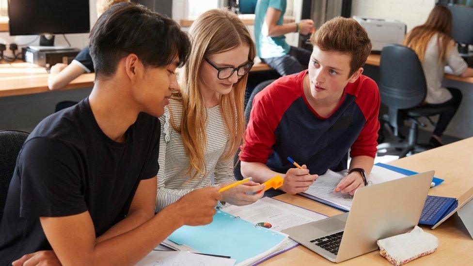 School pupils with a laptop